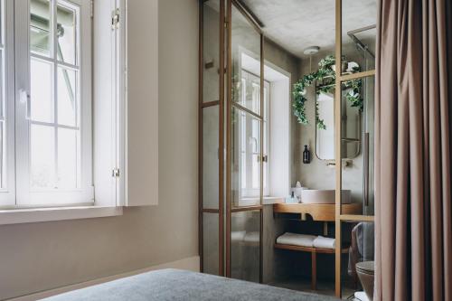 a bathroom with a sink and a mirror at Casa das Lérias in Amarante