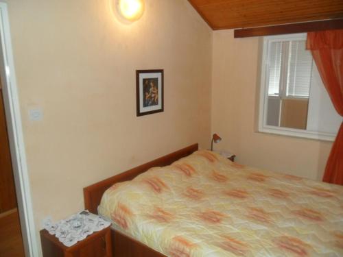 a bedroom with a bed and a window at Danko Apartments in Brna