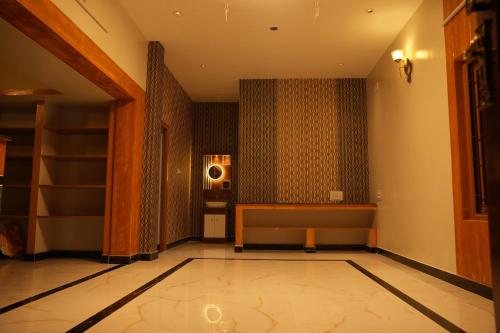 a hallway with a room with a couch and a speaker at Little Hearts in Chennai