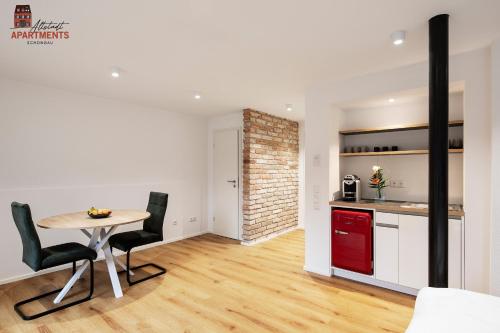a kitchen and dining room with a table and chairs at Altstadt Apartments in Schongau