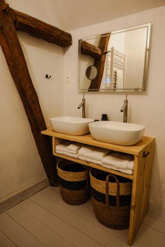 a bathroom with two sinks and a mirror at Vakantiewoning BienViennue in Marcilly-sur-Vienne