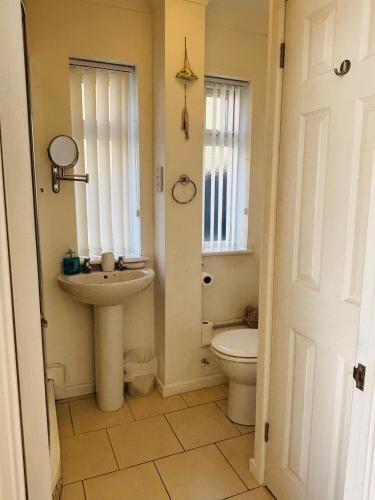 a bathroom with a sink and a toilet at The Corner Lodge in Portland