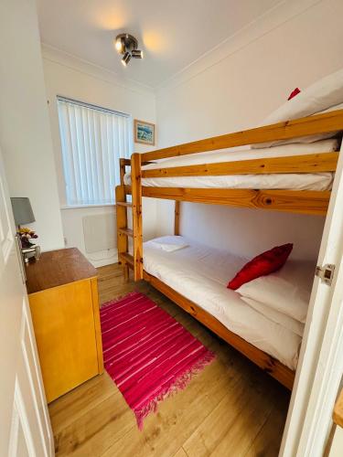 a bedroom with two bunk beds and a red rug at The Corner Lodge in Portland