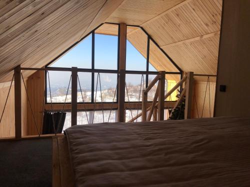 a bedroom with a large window in a tent at Dream house Almaty in Almaty