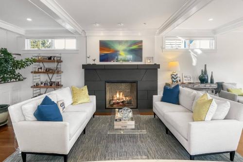a living room with two white couches and a fireplace at Waterside Haven in Branford