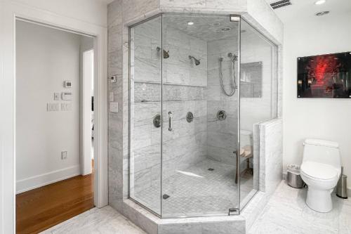 a glass shower in a bathroom with a toilet at Waterside Haven in Branford