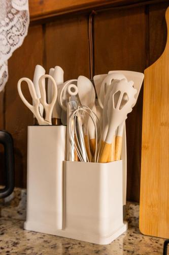 two white containers filled with utensils on a counter at Chillhaus in Piçarras