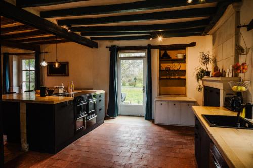 a kitchen with a sink and a stove top oven at Vakantiewoning BienViennue in Marcilly-sur-Vienne