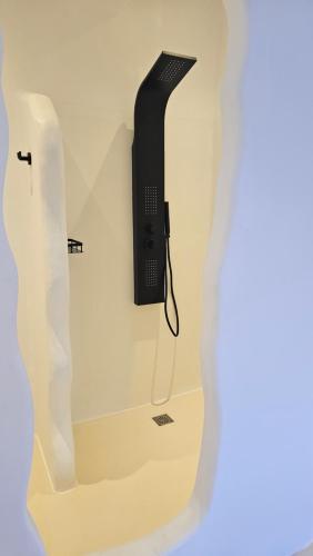 a black phone is hanging on a wall at ELLI TROPiCAL LUXURY SUITES SUNSET-INFINITY POOL- SEA SIDE-NEAR CENTER PARKING in Mikonos