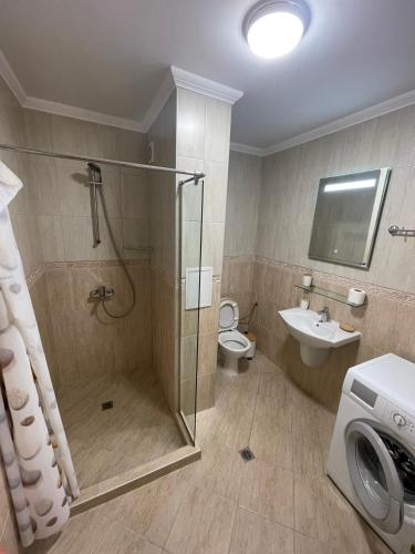 a bathroom with a shower and a toilet and a sink at Sunset in Chernomorets