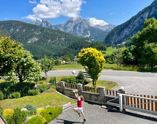 a woman playing with a frisbee in the mountains at Ferien am Sonnberg in Unken