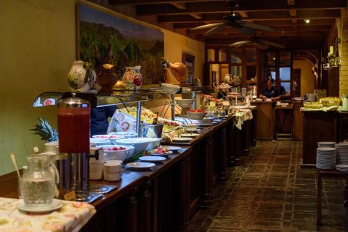 a buffet line in a restaurant with plates of food at Hotel Santa Cruz Plaza in Santa Cruz