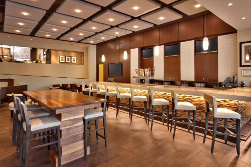 a restaurant with a long wooden table and chairs at Salt Lake City Marriott University Park in Salt Lake City