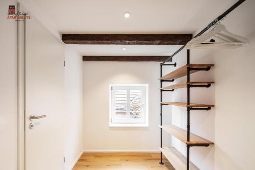 a room with a staircase and a window at Altstadt Apartments in Schongau