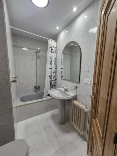 a bathroom with a sink and a bath tub at Alfonso X Lucus Confort in Lugo