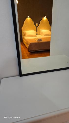 a reflection of a bedroom with a bed in a mirror at Kassiopi Apartmets4you III in Kassiopi
