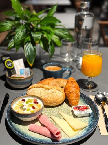 a table topped with a plate of bread and cheese at Hotel Arena Select in Valencia