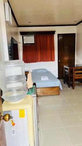 a small room with a bed and a table at Residencia Lourdes in Mactan