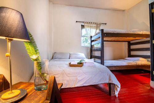a room with a bed and two bunk beds at Hotel Casa del Colibri in Güicán
