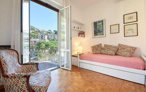 a bedroom with a bed and a window and a chair at Stunning Apartment In Camogli With Wifi in Camogli