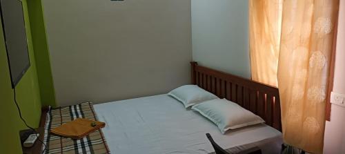 a small bedroom with a bed and a table at KPR Residency Near Isha - Adiyogi in Alāndurai
