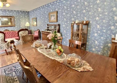 a dining room with a wooden table with fruit on it at Brownstone Spring Suite - Double Spa Tub Parking in Eureka Springs
