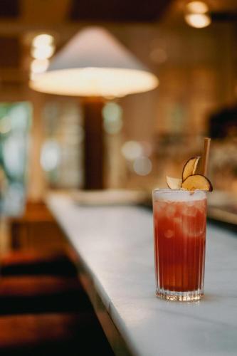 a drink sitting on top of a bar at Hotel Pulitzer Barcelona in Barcelona