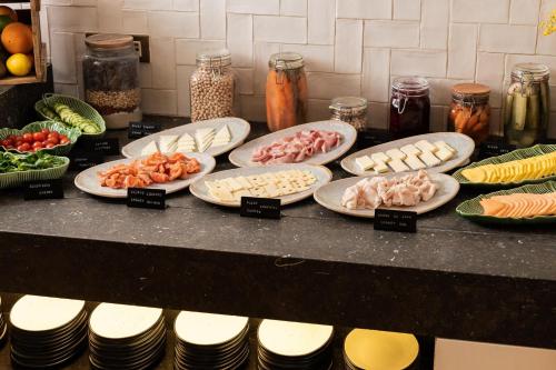 a bunch of plates of food on a counter at Hotel Pulitzer Barcelona in Barcelona