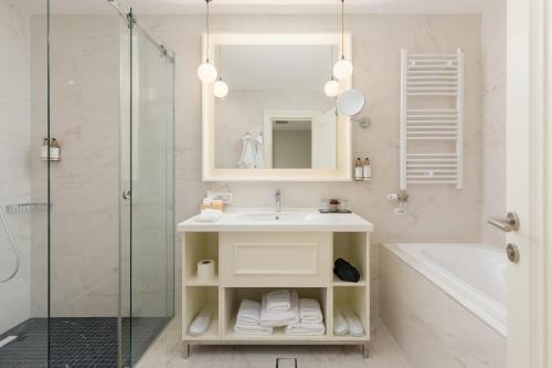 a bathroom with a sink and a shower at Heritage Grand Perast By Rixos in Perast