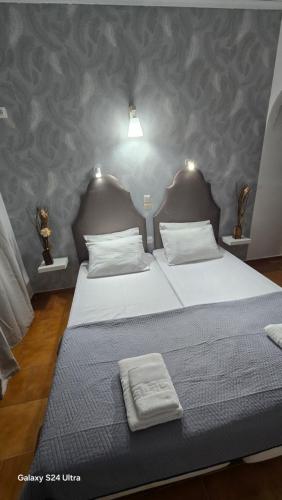 a bedroom with two beds with towels on them at Kassiopi Apartmets4you III in Kassiopi