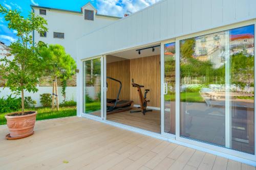 a room with sliding glass doors and a gym at Hotel Brattia, Adults Only, Heated Pool, A la Carte Breakfast, Postira, Brač Island in Postira
