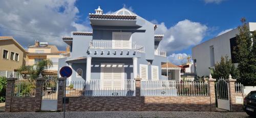 a white house with a fence in front of it at Dona Ana Guesthouse in Lagos