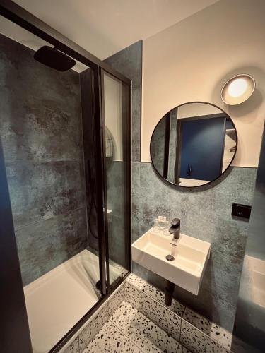a bathroom with a sink and a mirror at Hostel SLEPS in Augsburg