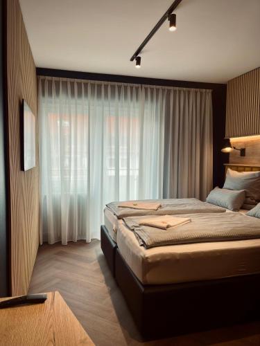 a bedroom with a large bed and a window at Hostel SLEPS in Augsburg