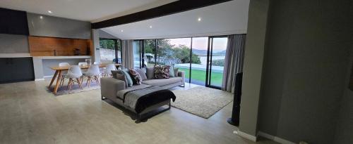 a living room with a couch and a table at Lagoon View Serenity! in Knysna
