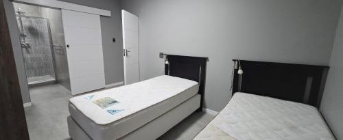 a bathroom with two beds and a mirror at Lagoon View Serenity! in Knysna