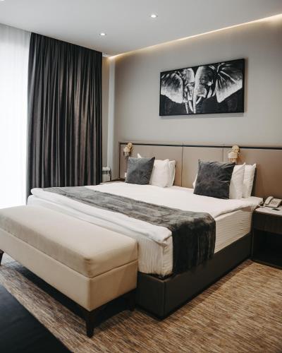 a hotel room with a large bed and a window at Port Marine Hotel By HOLLYWOOD in Baku