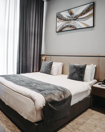 a hotel room with two beds in a room at Port Marine Hotel By HOLLYWOOD in Baku