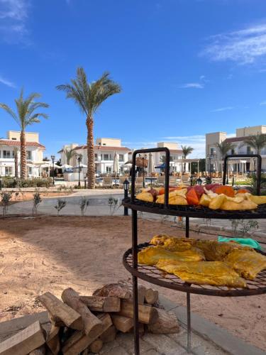 two shelves of breads on a beach with palm trees at Blue Residence Dahab in Dahab