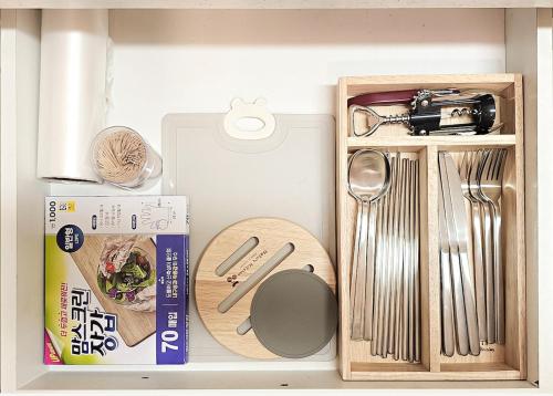 a drawer filled with kitchen utensils and a box at Lucky Vicky House in Seoul