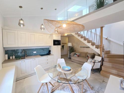 a kitchen and living room with a table and chairs at Marine Bliss in Savudrija