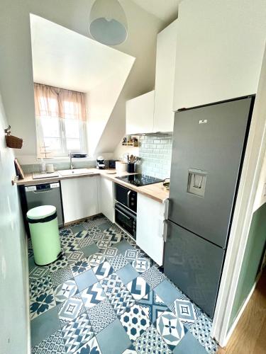 Il comprend une cuisine dotée de carrelage noir et blanc. dans l'établissement Perle Marine Haussmannienne - Lumineux & Calme - Proche Gare & Plage, à Dieppe