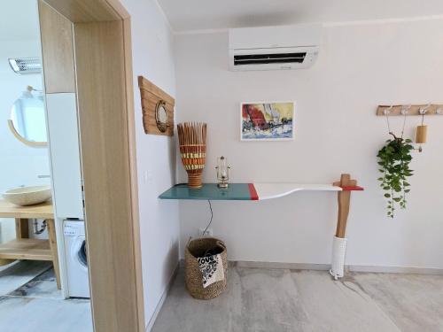a kitchen with a table and a clock on the wall at Marine Bliss in Savudrija