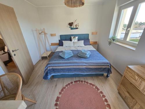 a bedroom with a bed with a blue comforter at Marine Bliss in Savudrija