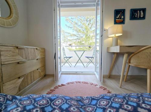 a bedroom with a door open to a balcony at Marine Bliss in Savudrija