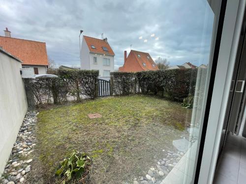 a view of a yard with a fence and a house at Modern and Bright home walk to beach with garage in Berck-sur-Mer