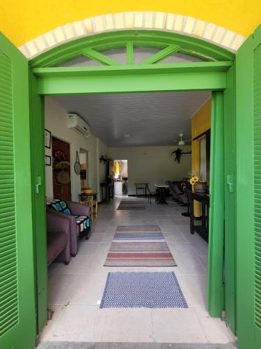 an open doorway to a living room with a green door at Rancho Bertotti in Guaratuba