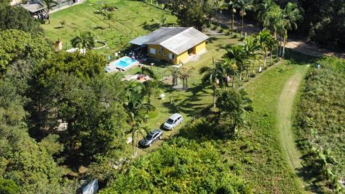 an aerial view of a house with cars parked in front at Rancho Bertotti in Guaratuba