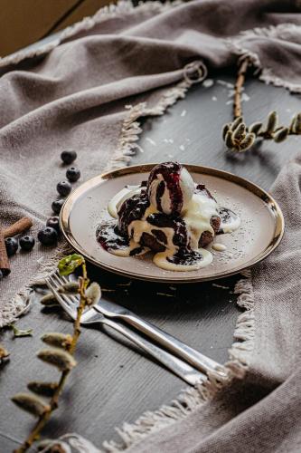 a plate with a dessert on a table at Ursa Mica Glamping Resort in Şirnea
