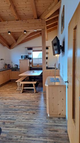 a kitchen with a table and a tv in a room at Haus Angelika im Zillertal in Hippach